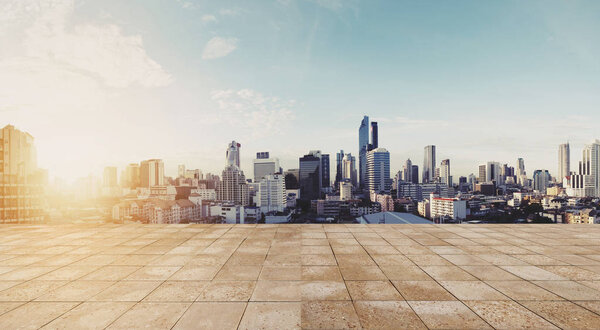 Panoramic city view in sunrise with empty wooden floor