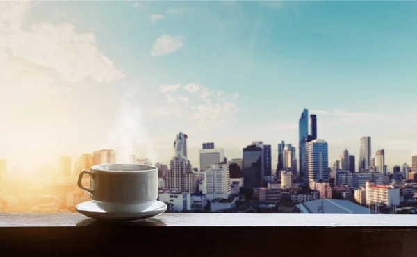 Morning hot coffee in sunrise, city backgrounds — Stock Photo, Image