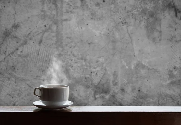 Cup of hot drinks with steam on wood table and concrete background, hot coffee, tea, chocolate and etc. — Stock Photo, Image
