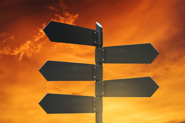 Blank road signpost, with sunset sky background