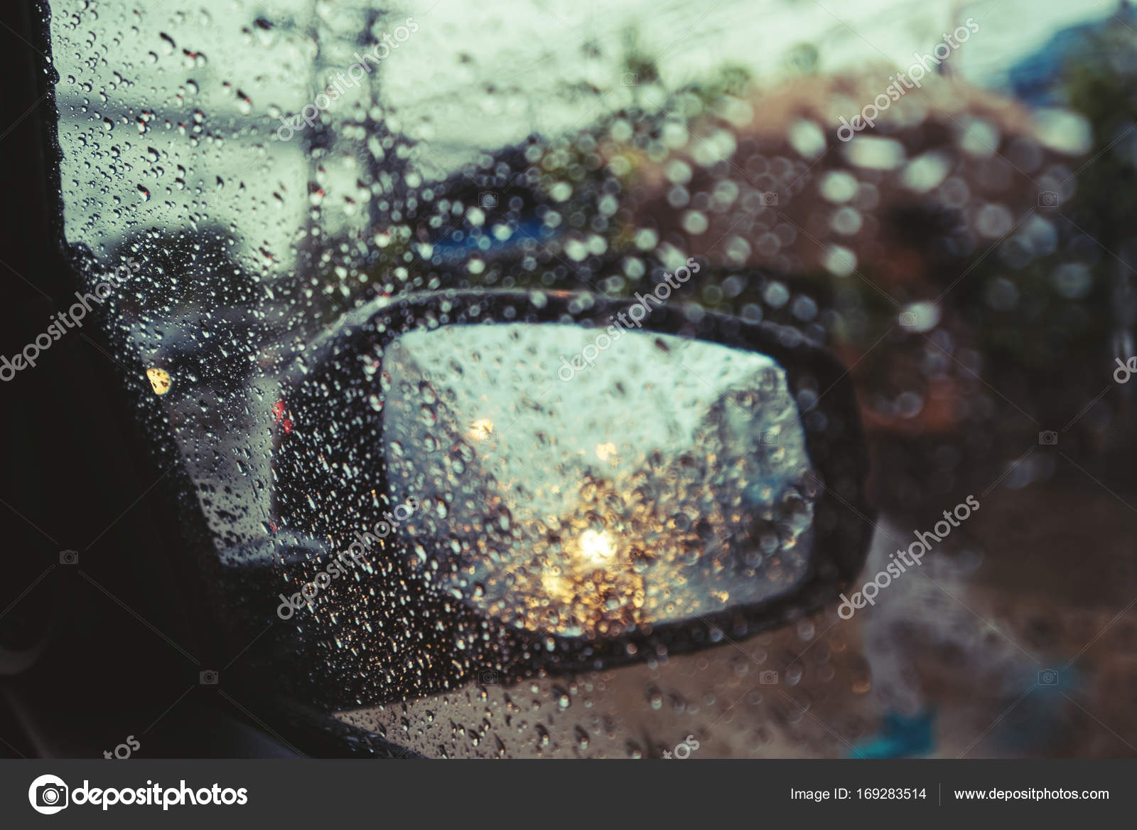 Rainy day on the road Raindrops on car mirror with side wing