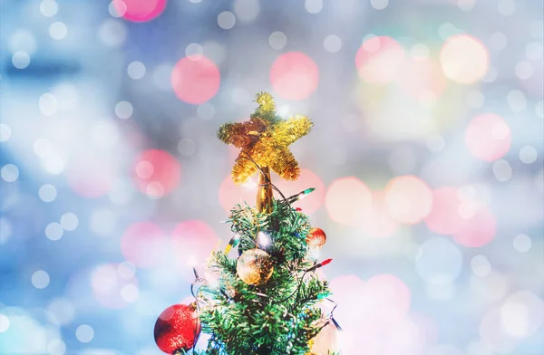 Christmas star on Christmas tree, soft Bokeh lights background