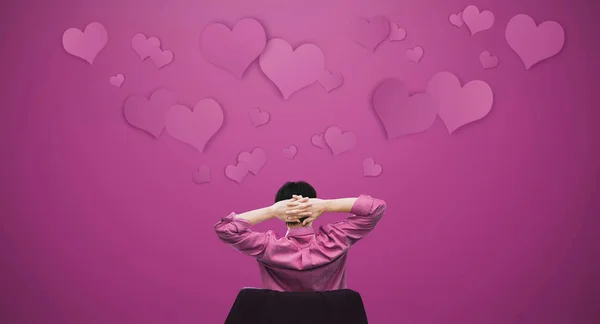 a man falling in love. Asian guy stretching arm with floating hearts. Valentines day concept