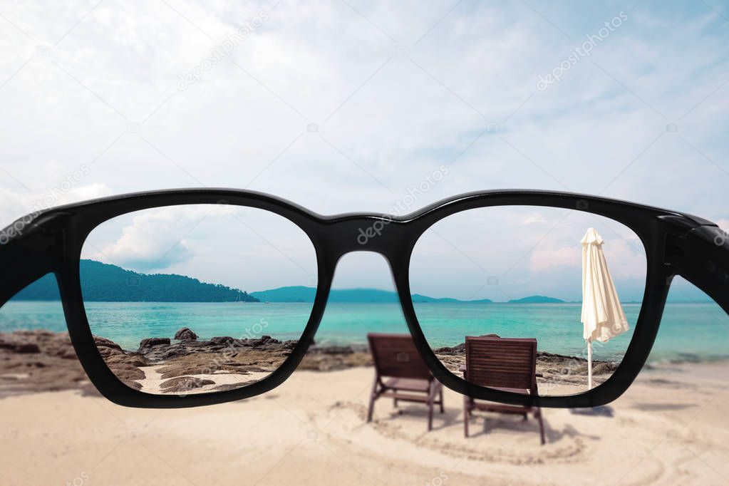Summer holiday and vacation. Looking through sunglasses lens to beautiful beach in summer