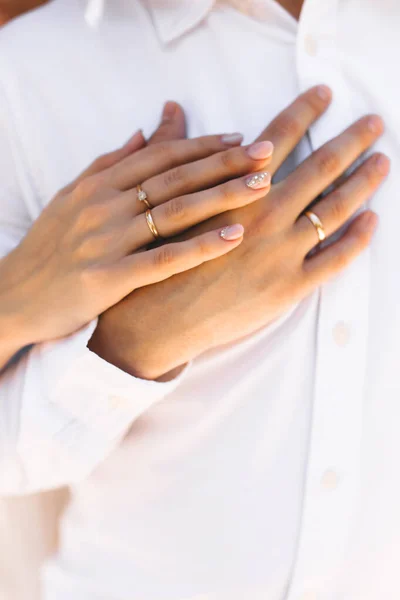 Руки с парой колец в день свадьбы на острове — стоковое фото
