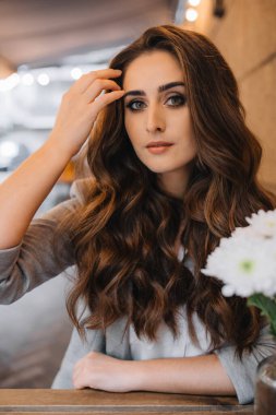 Young girl with professional makeup and hairstyle