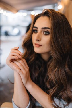 Young girl with professional makeup and hairstyle