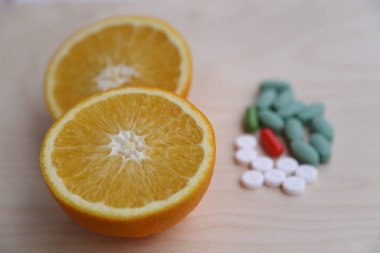 Choice between healthy lifestyle and lecture, choice between vitamin in orange or pills clipart