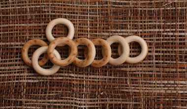 Masa manzarasında samanların üzerinde küçük ekmek halkaları