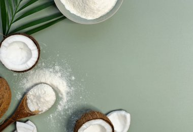 coconut flour and fresh coconuts on green background 