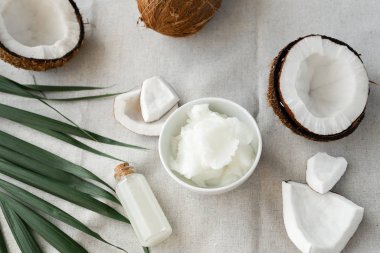image of coconut oil and fresh coconuts . 