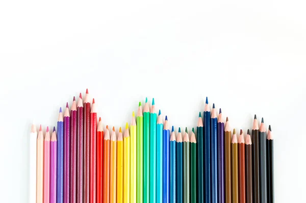 Crayons and watercolor pastels lined up isolated on white — Stock Photo, Image