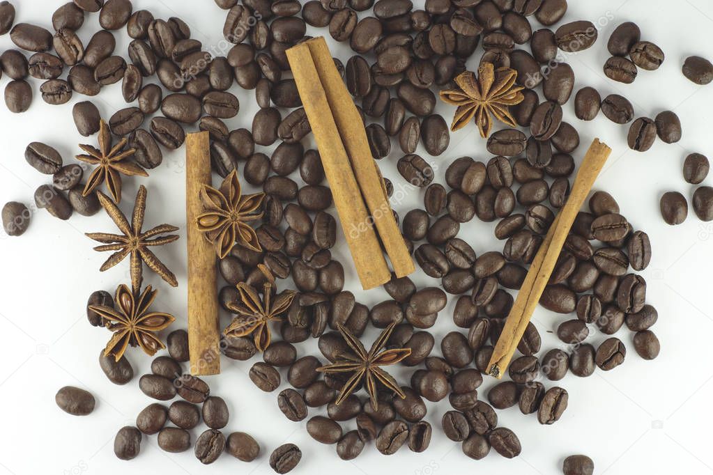 Cinnamon sticks with anise star and coffee beans on white backgr