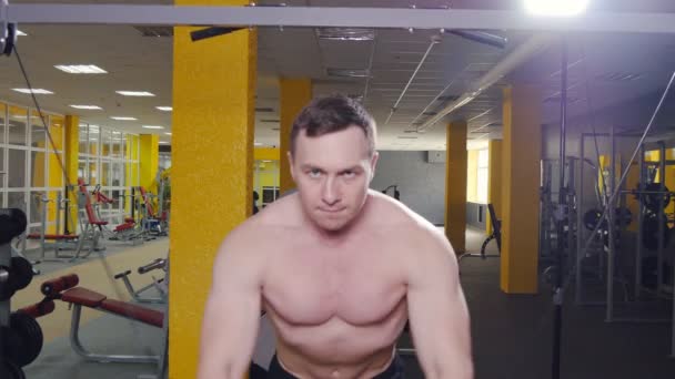 O homem treina bíceps no ginásio — Vídeo de Stock