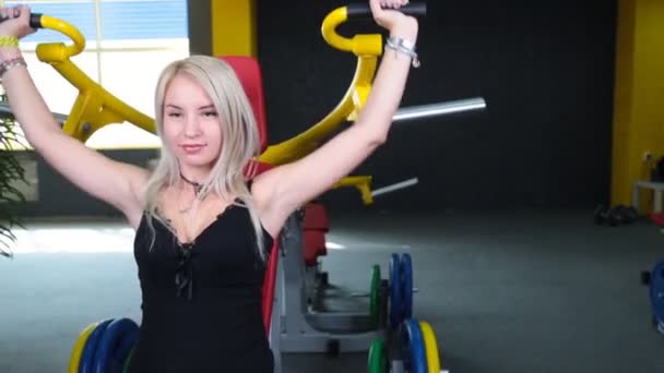 Mladí fitness model vyjde na školení přístroje uvnitř ve fitness centru — Stock video