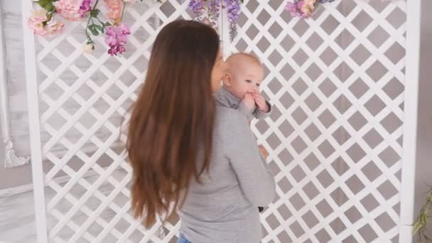 Young mother is holding her little baby — Stock Video