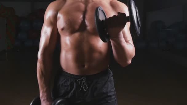 Handsome power athletic man with dumbbell — Stock Video