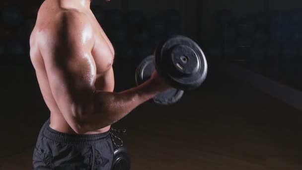 Muscular culturista chico haciendo ejercicios con sombrillas — Vídeo de stock