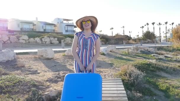 Mujer joven feliz de vacaciones con una maleta — Vídeos de Stock
