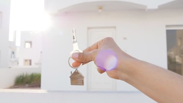 Eine Hand hält einen Schlüssel aus der neuen Wohnung — Stockvideo