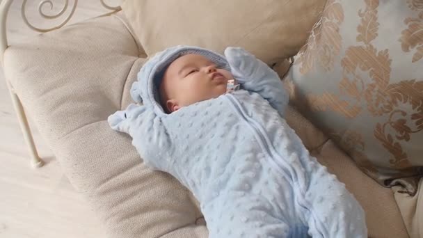 Cute baby boy lying on the couch — Stock Video