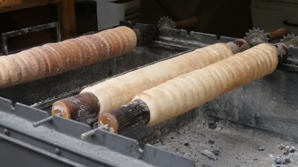 Trdelnik bakken op de straat van Praag. — Stockvideo