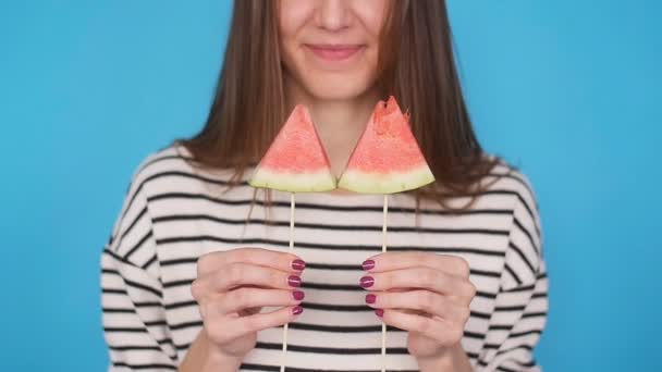 Beautiful young woman holding slice of watermelon and smiling — Stock Video