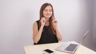 Mutlu başarılı beyaz bir kadın arıyor ve kameraya gülümseyen gözlük