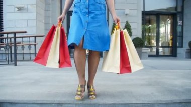 Alışveriş torbaları dükkandan çıkıp olan mutlu kadın