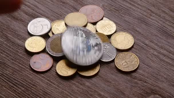 Биткоины и другие монеты падают на стол — стоковое видео