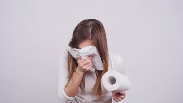 Woman sneezing in a tissue on the white background — Stock Video