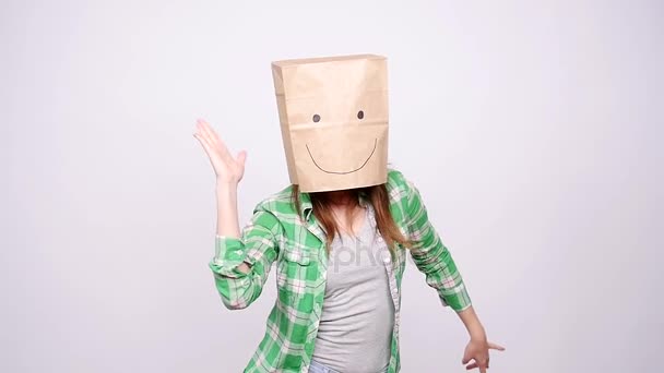 Happy woman with a paper bag on her head dancing — Stock Video