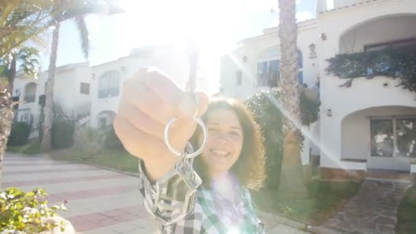 Mujer joven feliz en frente de un nuevo hogar con llaves — Vídeos de Stock