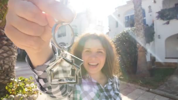 Happy young Woman moving into new home. Showing keys of new property — Stock Video