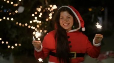 Kırmızı kazaklı Holding havai fişek, Noel kavramı içinde mutlu Umman.