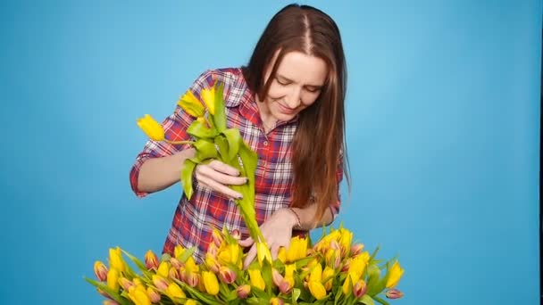 Jeune fleuriste femelle avec grande boîte de tulipes jaunes — Video