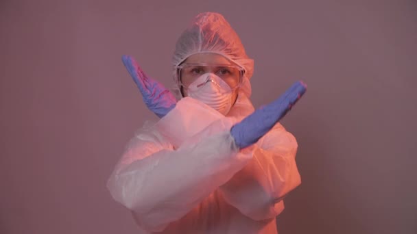 Woman in protective suit in quarantine zone signed stop. Coronovirus and isolation concept — Stock Video