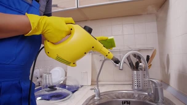 House cleaning concept. Man cleaning kitchen with steam cleaner — Stock Video