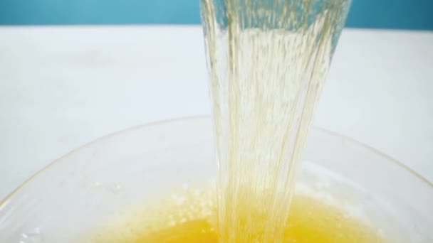 Schönheits- und Körperpflegekonzept. Flüssige gelbe Zuckerpaste oder Wachs zum Enthaaren auf blauem Hintergrund — Stockvideo