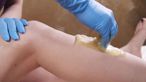 Mulher no Spa recebendo pernas enceradas para depilação em câmera lenta — Vídeo de Stock