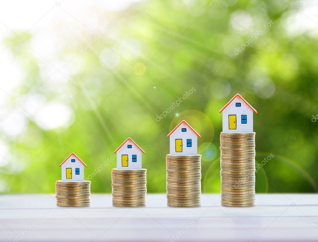 House model and coin money,mortgage and real estate investment.