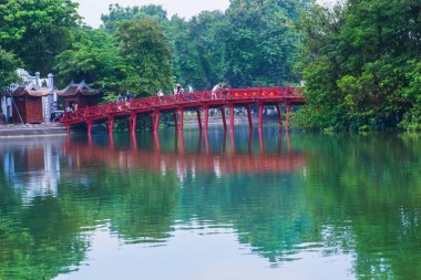 Hanoi, Vietnam - August 2016. Hanoi Red Bridge.The wooden red-painted bridge over the Hoan Kiem Lake connects the shore and the Jade Island on which Ngoc Son Temple stands. Hanoi on August 12, 2016 clipart