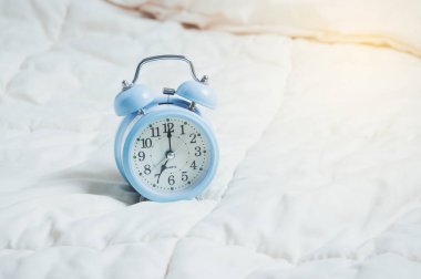 Yatakta mavi alarm, uyanma konsepti..