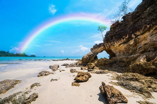 Colorful rainbow over the sea,Natural arch rock landscape, View of the natural arch Koh Phayam,Thailand.