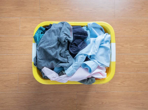 Top view Clothes in a laundry basket on floor.