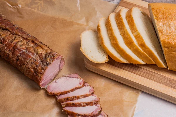 Plakjes gerookt vlees of ham op bruin verpakking papier. Sneetjes wit w — Stockfoto