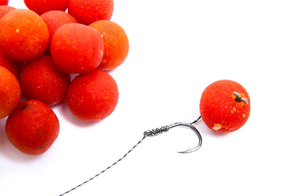 Carp fishing. Carp hook red boilies isolated on white background