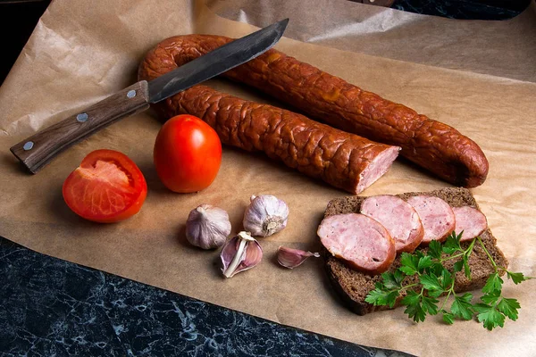 Slices of smoked sausage with spice, herbs and vegetables on the