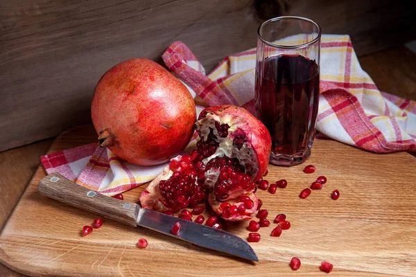 Grenade rouge fraîche avec couteau vintage et verre de rudy frais — Photo