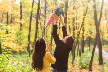 aşk, ebeveynlik, Aile, sezon ve insanlar kavramı - çift bebek sonbahar Park ile gülümseyen